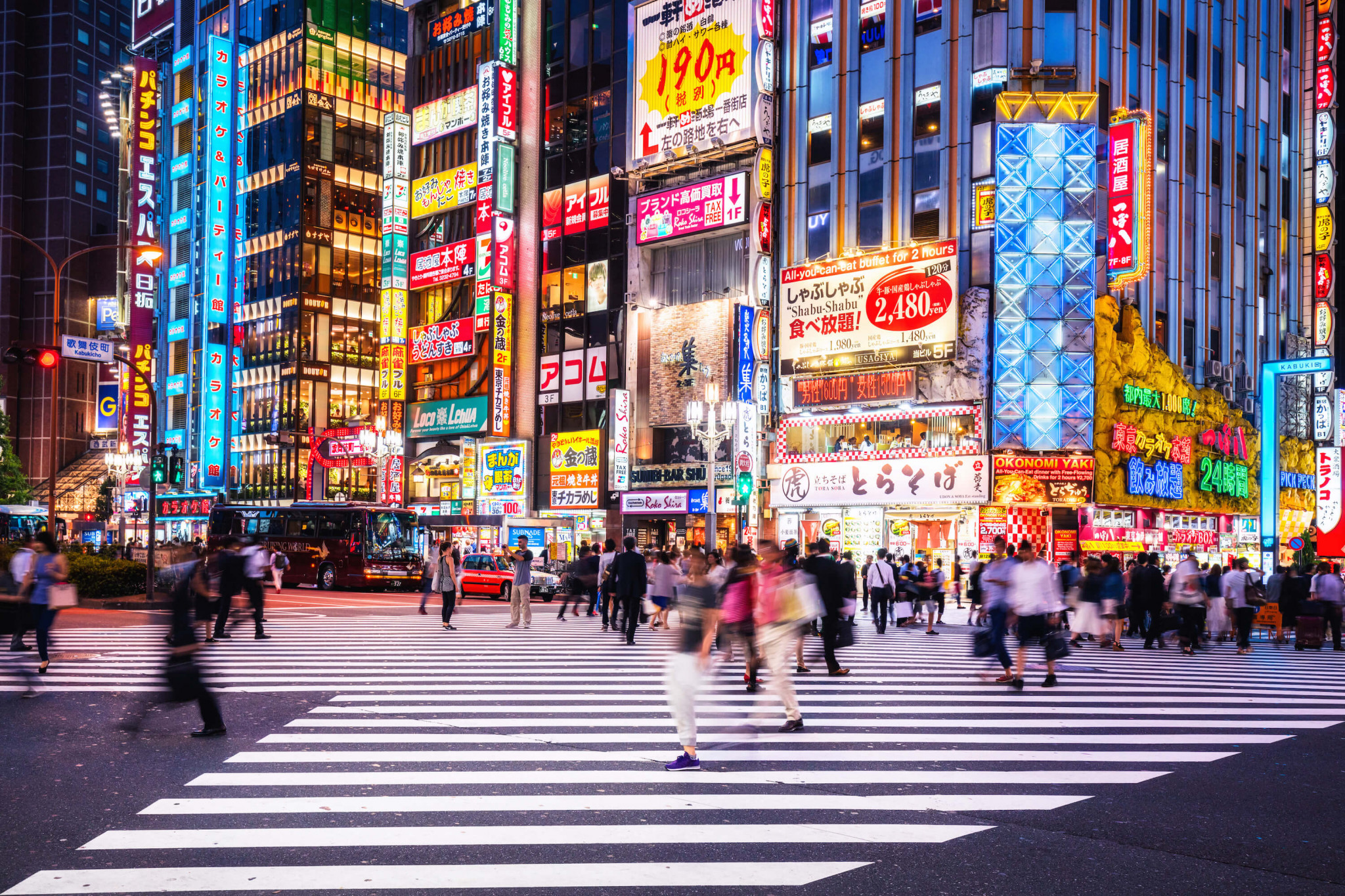 street scene with japanese buildings and people on a crossing